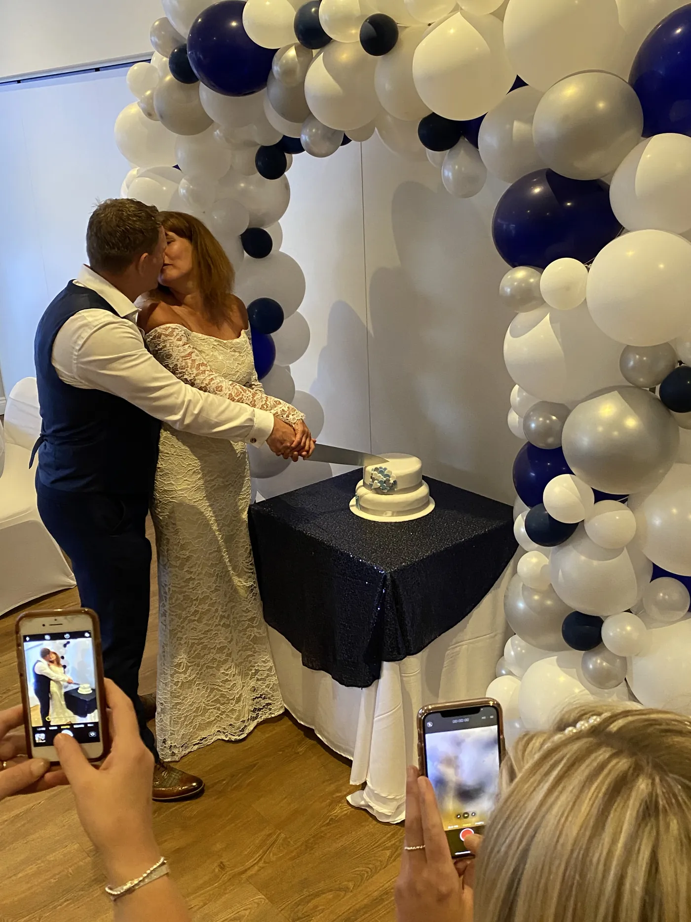 A couple cutting their cake in the Squires suite