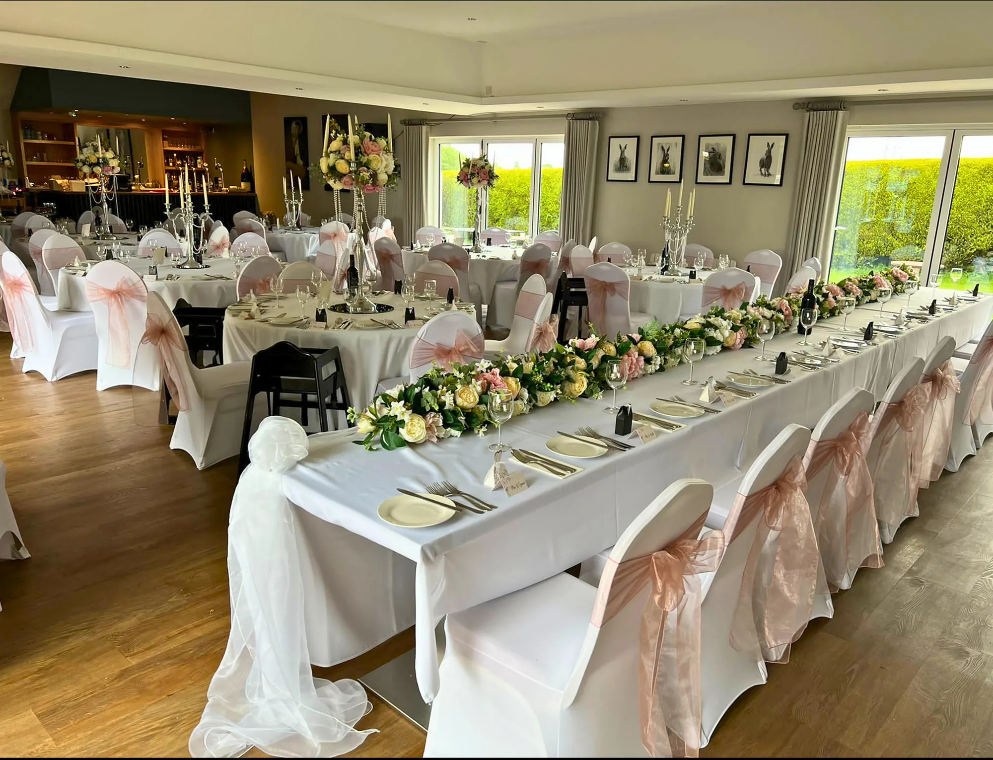 A long table dressed with a floral runner in the Squires suite
