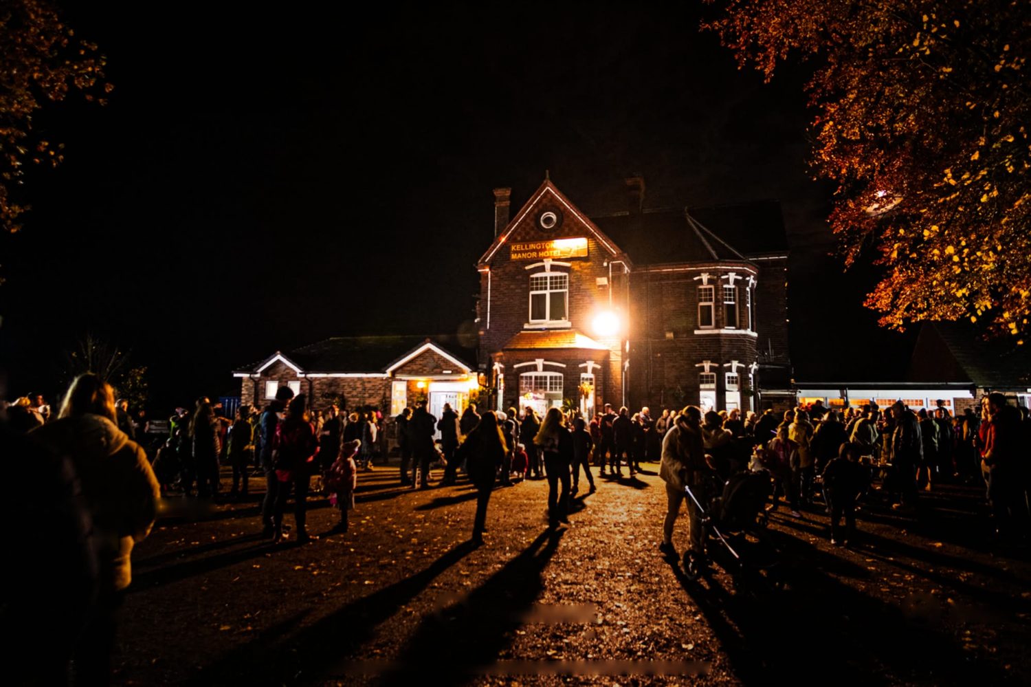 A crowd gathered outside the lit-up manor on bonfire night